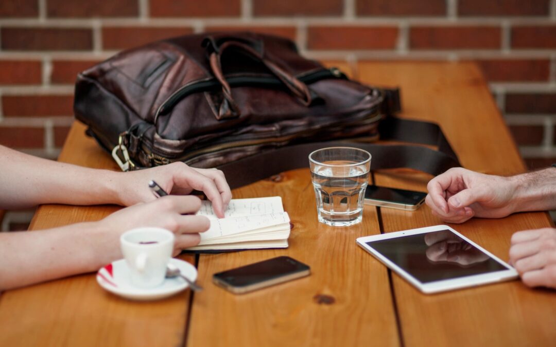 Two people at a desk working.